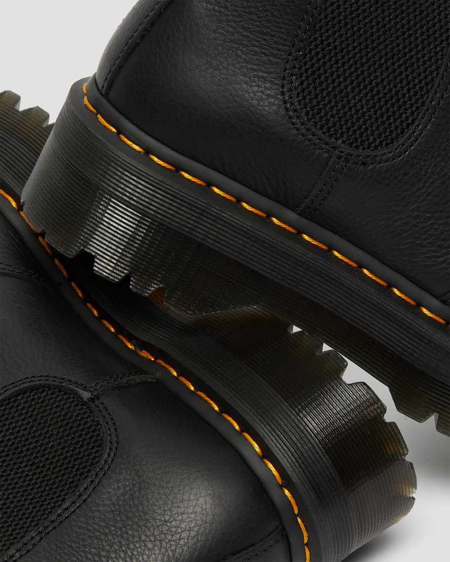 schwarze dr. martens 2976 chelsea boots mit kunstfellfutter und plateausohle für damen.